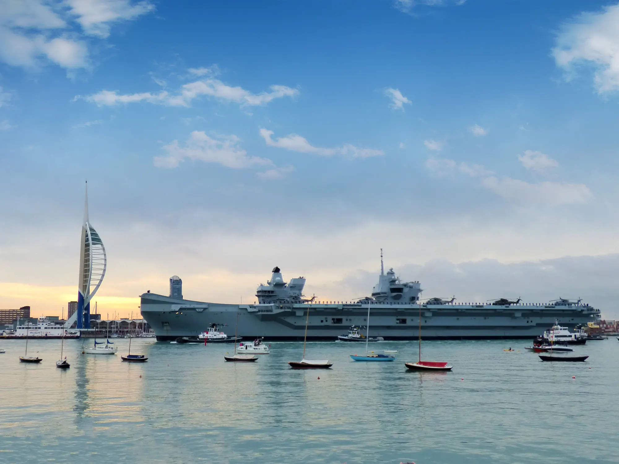 Royal Navy aircraft carrier passing the Spinnaker Tower in Portsmouth Harbour