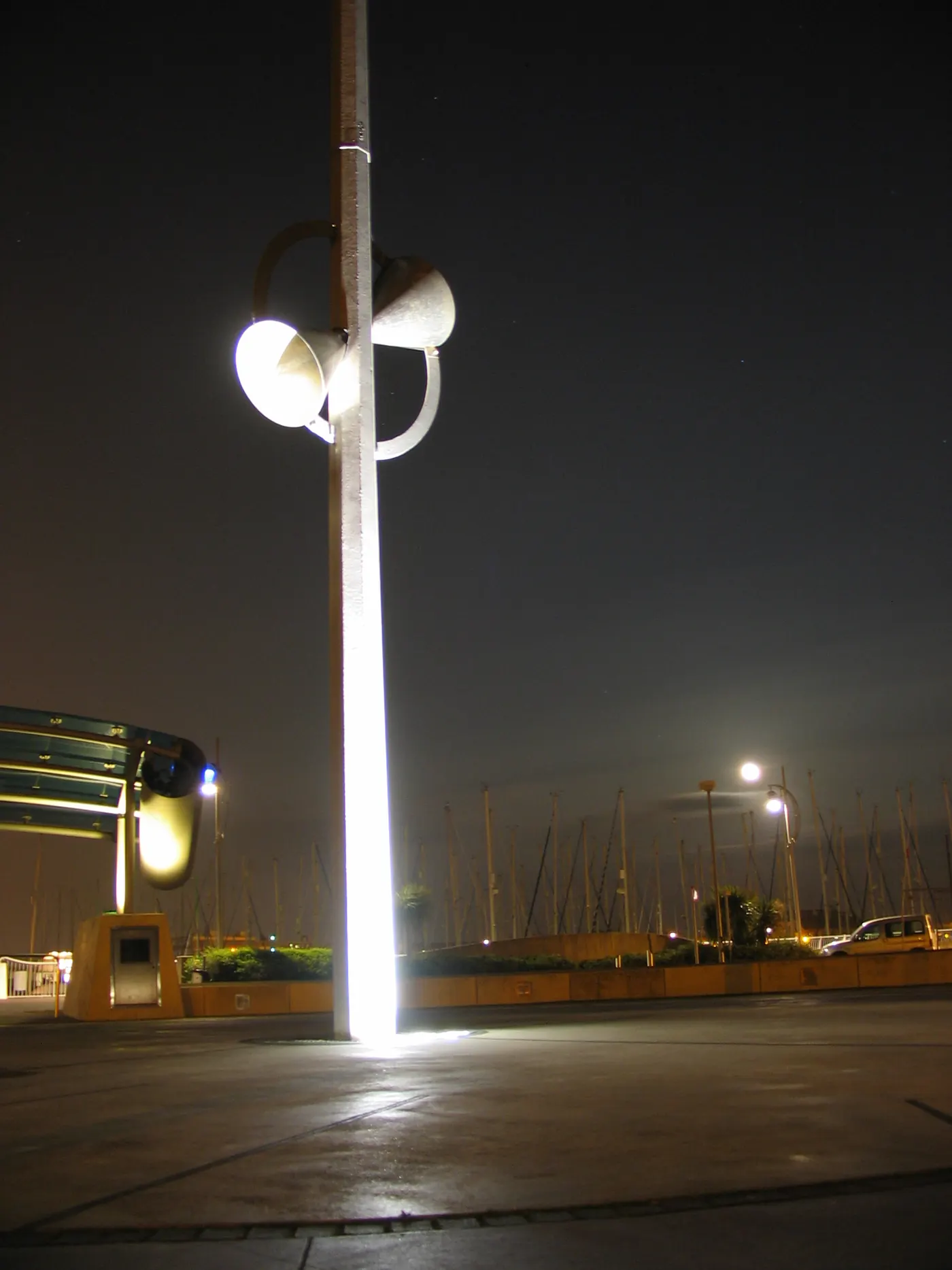 A marina at night, with boat masts silhouetted against the sky